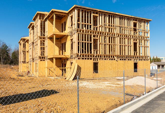 a temporary chain link fence winding around a construction site, outlining the project's progress in Lynwood CA